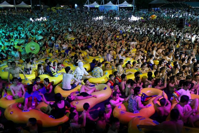 People enjoy a music party inside a swimming pool at the Wuhan Maya Beach Park, in Wuhan, China. REUTERS/Stringer